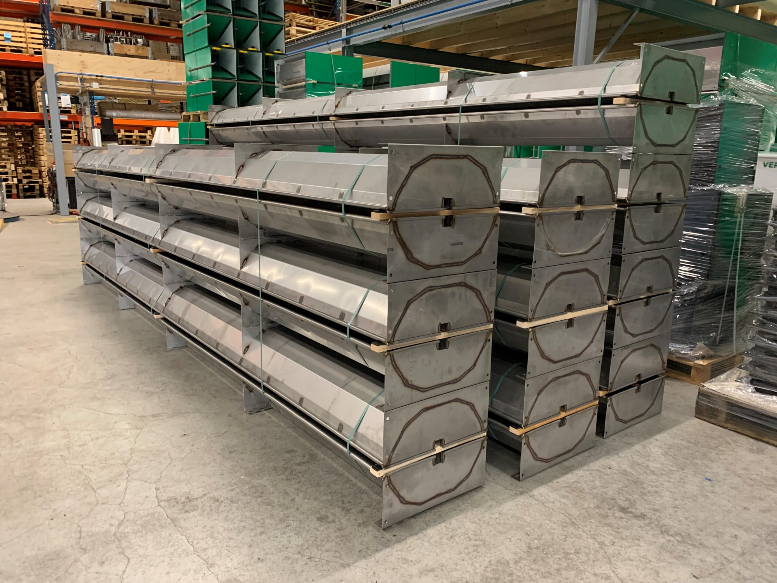 Stainless steel pig troughs ready for transport Stainless steel pig trough with a fenced edge